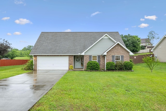 2236 Kim Dr, Clarksville, TN 37043 - view of front of property featuring brick siding, an attached garage, driveway, and roof with shingles