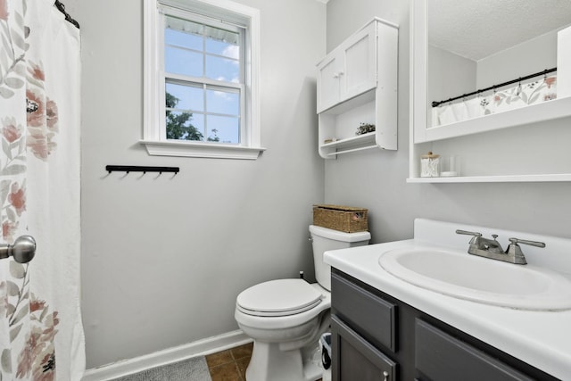 2236 Kim Dr, Clarksville, TN 37043 - bathroom featuring toilet, vanity, tile patterned flooring, baseboards, and a textured ceiling
