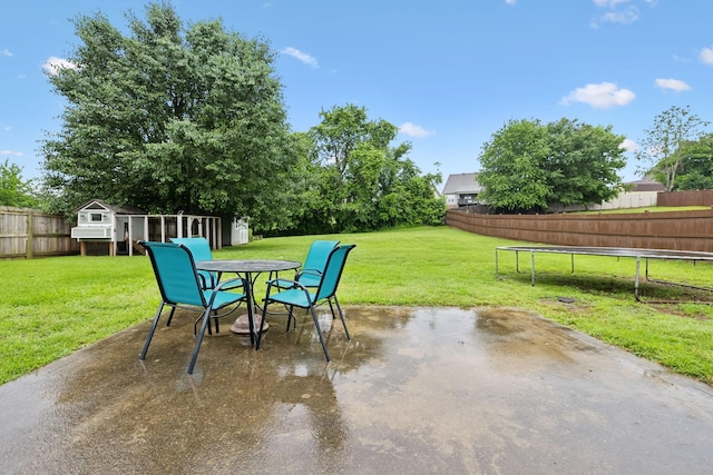 2236 Kim Dr, Clarksville, TN 37043 - view of patio / terrace featuring a trampoline, outdoor dining space, and an outbuilding