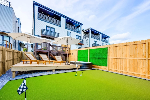 10B Fern Ave, Nashville, TN 37207 - rear view of property with a putting area, a fenced backyard, a wooden deck, and stairs