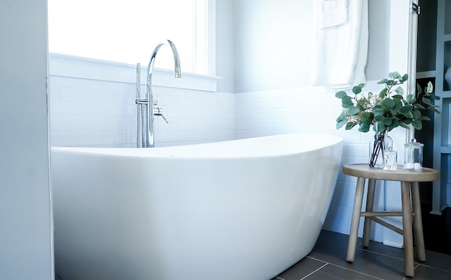 10B Fern Ave, Nashville, TN 37207 - full bathroom with a sink, tile walls, a freestanding bath, tile patterned floors, and a wainscoted wall