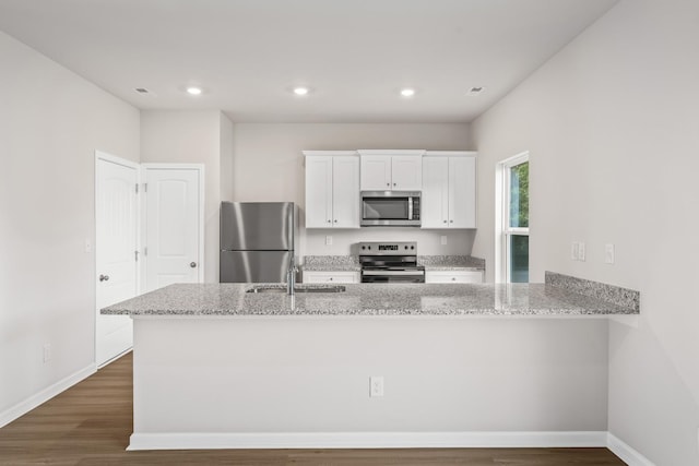 2028 Lala Loop, White Bluff, TN 37187 - kitchen with appliances with stainless steel finishes, a sink, light stone counters, white cabinets, and baseboards