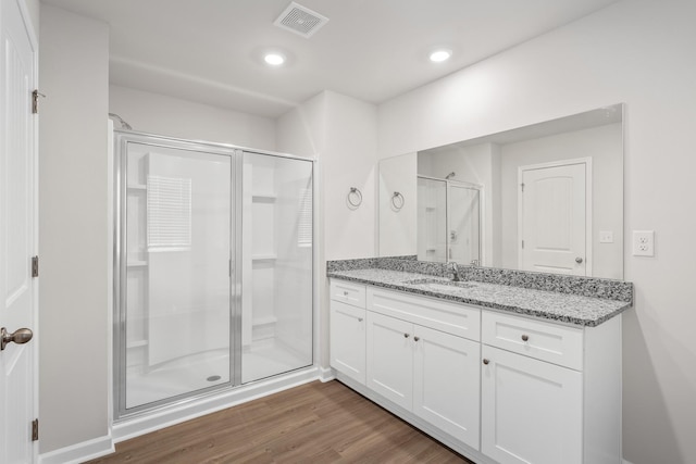 2046 Lala Loop, White Bluff, TN 37187 - bathroom featuring a stall shower, vanity, wood finished floors, and recessed lighting