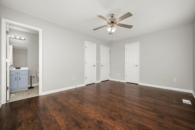380 Strawberry Dr, Winchester, TN 37398 - unfurnished bedroom with baseboards, wood finished floors, two closets, and connected bathroom