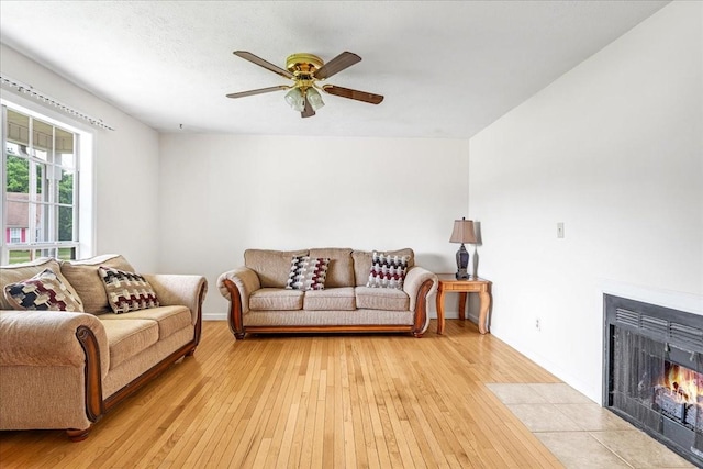 1910 Burlington Cir, Columbia, TN 38401 - living room featuring light wood-style flooring, a ceiling fan, a fireplace with flush hearth, and baseboards