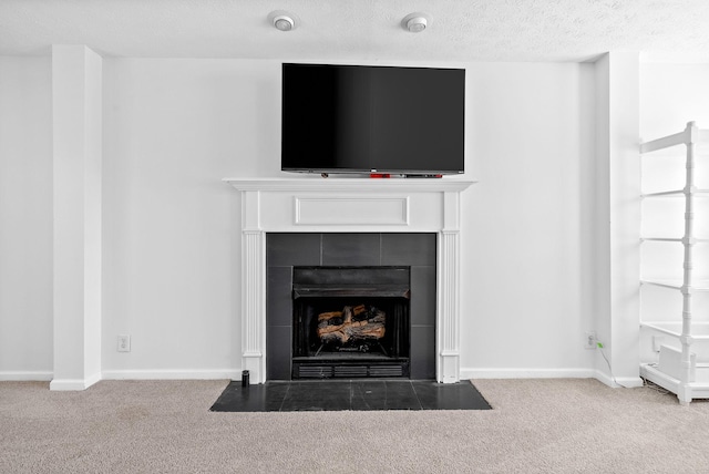 2829 Sharpie Dr, Clarksville, TN 37040 - detailed view of carpet flooring, a tiled fireplace, baseboards, and a textured ceiling
