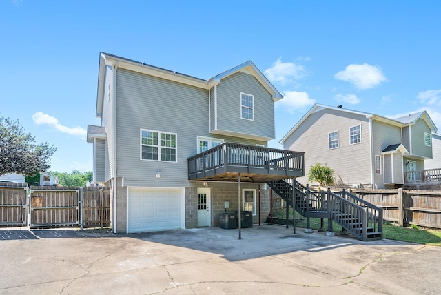 2829 Sharpie Dr, Clarksville, TN 37040 - back of property with a deck, concrete driveway, stairway, and a garage