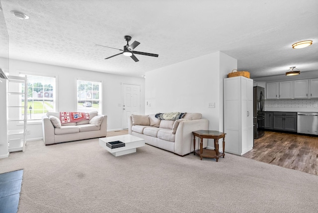 2829 Sharpie Dr, Clarksville, TN 37040 - living room featuring dark colored carpet, a ceiling fan, baseboards, and a textured ceiling