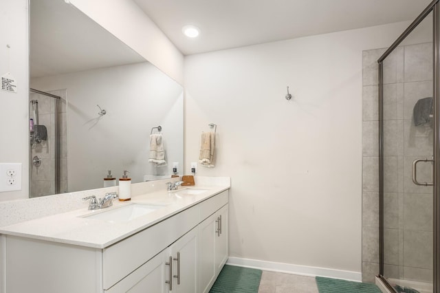 705 Watson Ct, Spring Hill, TN 37174 - bathroom featuring double vanity, a shower stall, tile patterned flooring, and baseboards