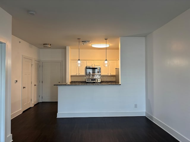 934 Governors Ct Unit 304, Antioch, TN 37013 - kitchen featuring stainless steel appliances, dark stone counters, baseboards, backsplash, and white cabinets