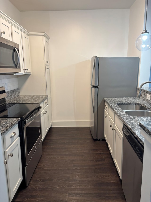 934 Governors Ct Unit 304, Antioch, TN 37013 - kitchen with stainless steel appliances, a sink, dark wood-type flooring, baseboards, and dark stone counters