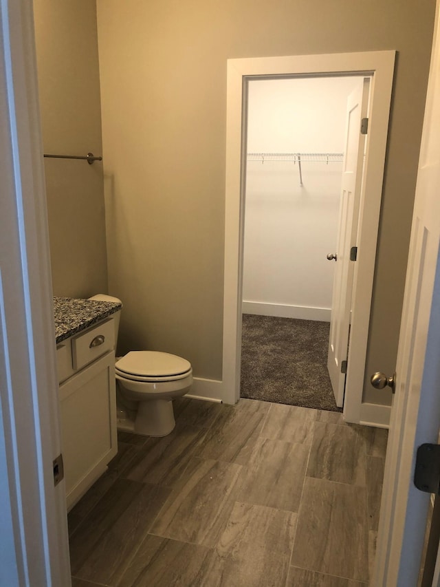 934 Governors Ct Unit 302, Antioch, TN 37013 - bathroom with wood finished floors, toilet, a spacious closet, and vanity