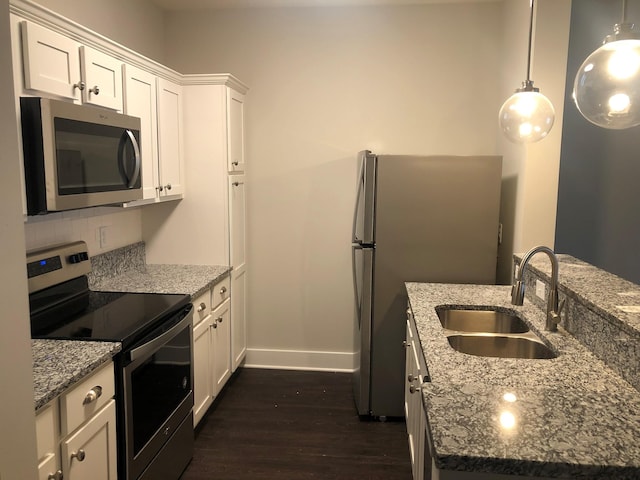 934 Governors Ct Unit 302, Antioch, TN 37013 - kitchen featuring appliances with stainless steel finishes, a sink, dark wood-type flooring, baseboards, and white cabinets
