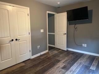 117 Raspberry Dr, Winchester, TN 37398 - unfurnished bedroom featuring baseboards, dark wood-type flooring, and a closet