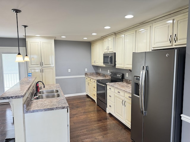 117 Raspberry Dr, Winchester, TN 37398 - kitchen featuring appliances with stainless steel finishes, cream cabinetry, a kitchen island with sink, dark wood-style flooring, and recessed lighting