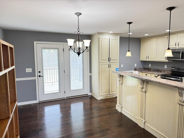 117 Raspberry Dr, Winchester, TN 37398 - kitchen featuring black electric range oven, stainless steel microwave, cream cabinetry, light stone counters, and dark wood finished floors