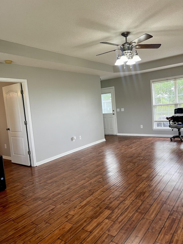 126 E Laurel Dr, Lawrenceburg, TN 38464 - empty room with a ceiling fan, a textured ceiling, dark wood-type flooring, and baseboards