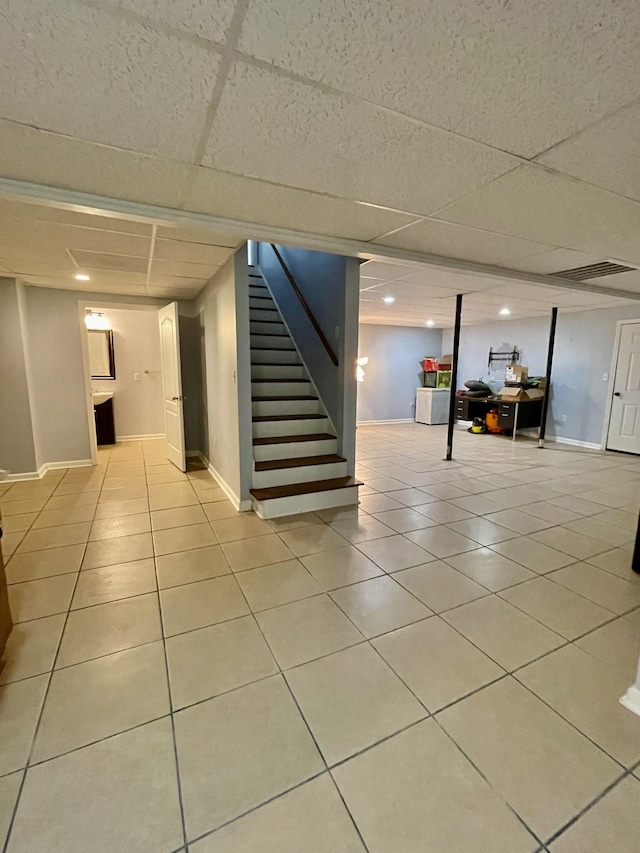 126 E Laurel Dr, Lawrenceburg, TN 38464 - finished below grade area featuring a paneled ceiling, stairs, tile patterned flooring, and baseboards