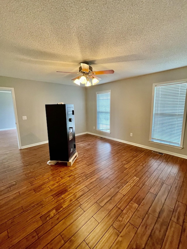 126 E Laurel Dr, Lawrenceburg, TN 38464 - empty room featuring a textured ceiling, wood finished floors, a ceiling fan, and baseboards