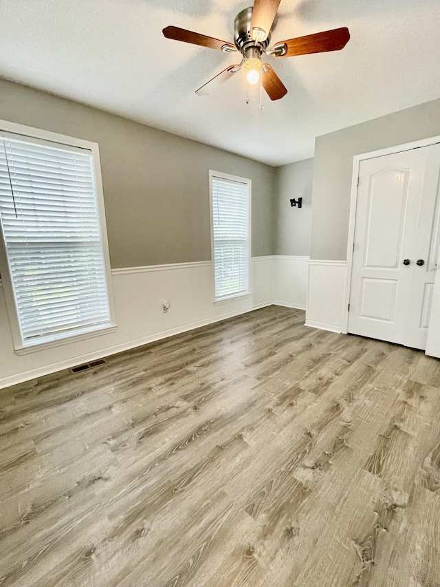 126 E Laurel Dr, Lawrenceburg, TN 38464 - unfurnished room featuring ceiling fan, wainscoting, and wood finished floors