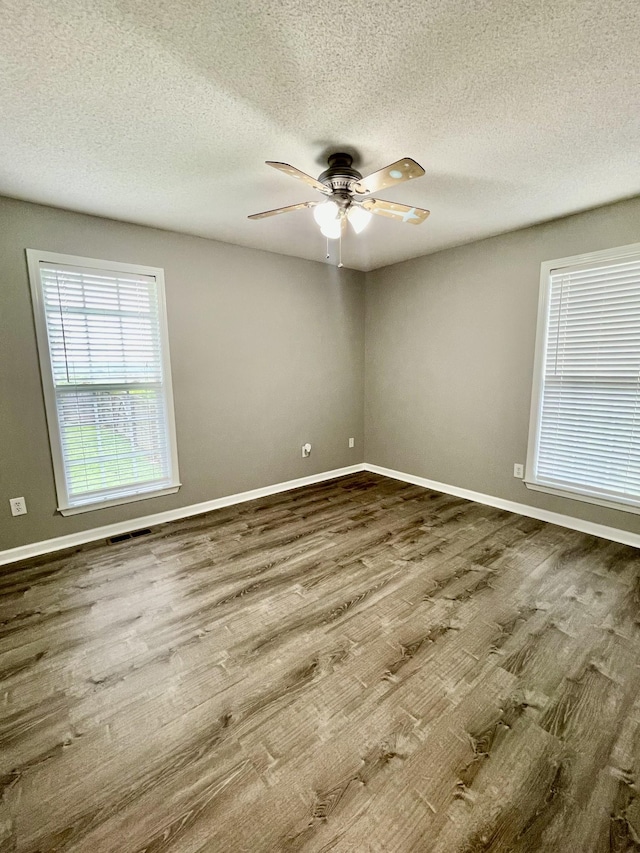 126 E Laurel Dr, Lawrenceburg, TN 38464 - empty room featuring wood finished floors, a textured ceiling, a ceiling fan, and baseboards