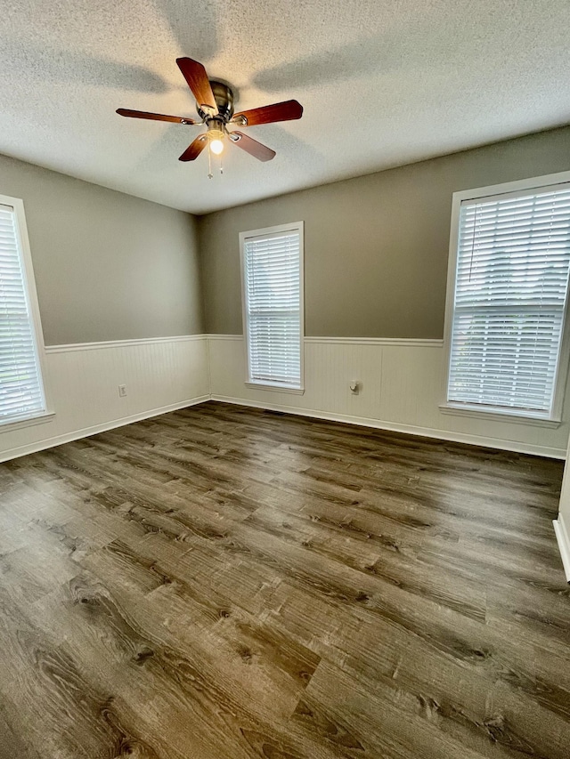 126 E Laurel Dr, Lawrenceburg, TN 38464 - spare room featuring wainscoting, wood finished floors, ceiling fan, and a textured ceiling