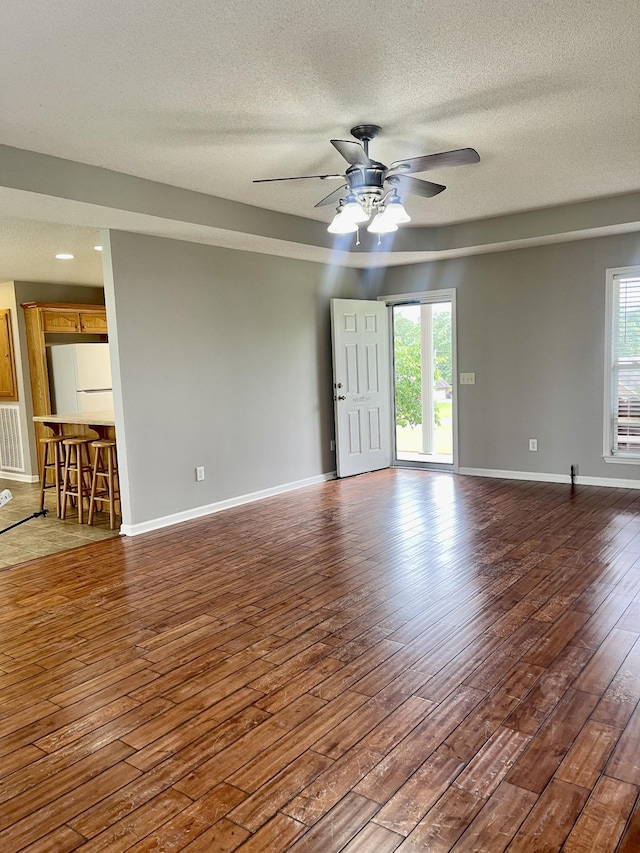 126 E Laurel Dr, Lawrenceburg, TN 38464 - unfurnished room with wood-type flooring, a ceiling fan, healthy amount of natural light, a textured ceiling, and baseboards