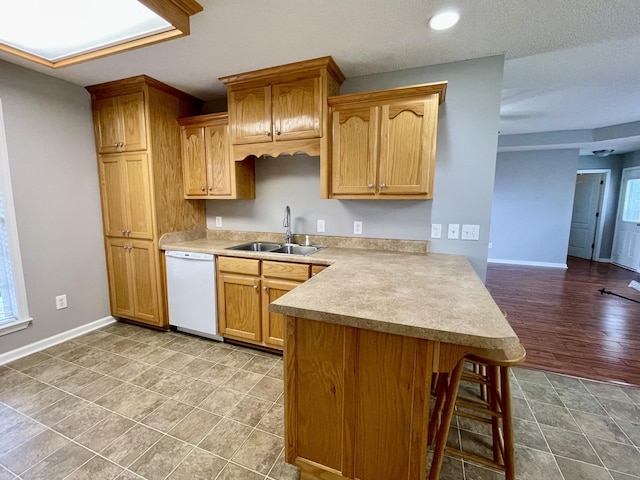 126 E Laurel Dr, Lawrenceburg, TN 38464 - kitchen featuring white dishwasher, a sink, a peninsula, light countertops, and baseboards