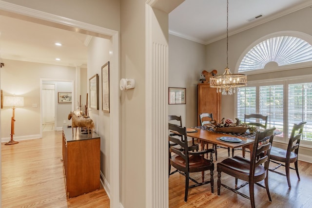 1339 Ashes Ave, Soddy Daisy, TN 37379 - dining room with light wood finished floors, ornamental molding, a chandelier, and baseboards