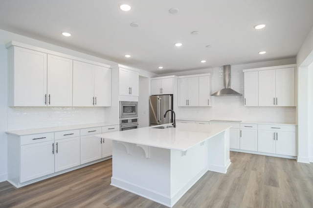 120 W Cassa Way, Mount Juliet, TN 37122 - kitchen featuring wall chimney exhaust hood, stainless steel appliances, tasteful backsplash, light wood-style floors, and recessed lighting