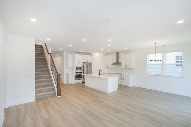 122 W Cassa Way, Mount Juliet, TN 37122 - kitchen with wall chimney range hood, a sink, a kitchen breakfast bar, appliances with stainless steel finishes, and light countertops