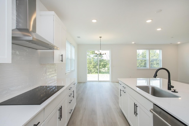 122 W Cassa Way, Mount Juliet, TN 37122 - kitchen with wall chimney exhaust hood, black electric cooktop, a sink, stainless steel dishwasher, and recessed lighting