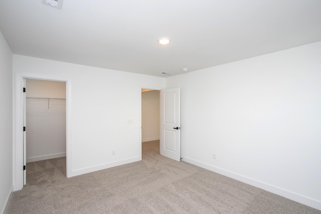 122 W Cassa Way, Mount Juliet, TN 37122 - unfurnished bedroom with light colored carpet, baseboards, a walk in closet, and a closet