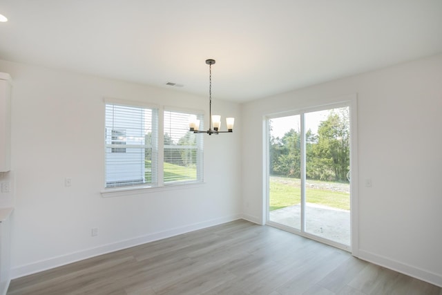 122 W Cassa Way, Mount Juliet, TN 37122 - unfurnished dining area featuring healthy amount of natural light, a chandelier, light wood-style flooring, and baseboards