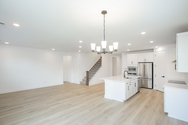 122 W Cassa Way, Mount Juliet, TN 37122 - kitchen with appliances with stainless steel finishes, a kitchen island with sink, recessed lighting, light wood-style flooring, and a sink