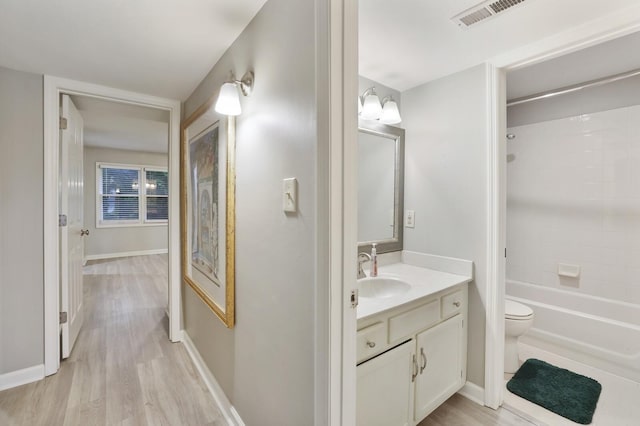2433 Kennedy Ct Unit 2433, Franklin, TN 37064 - bathroom with vanity, toilet, wood finished floors, bathing tub / shower combination, and baseboards