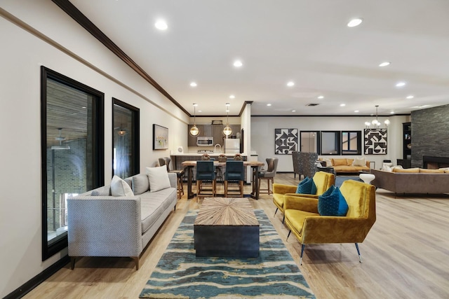 2433 Kennedy Ct Unit 2433, Franklin, TN 37064 - living area featuring crown molding, light wood finished floors, recessed lighting, a fireplace, and baseboards