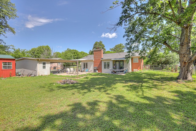 1111 Greenhill St, Murfreesboro, TN 37129 - back of property featuring a chimney, a patio area, and an outdoor structure