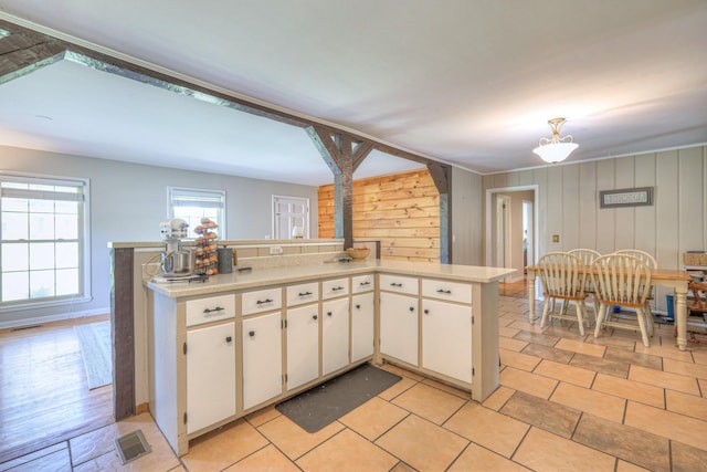 1111 Greenhill St, Murfreesboro, TN 37129 - kitchen with light countertops, white cabinetry, and wooden walls