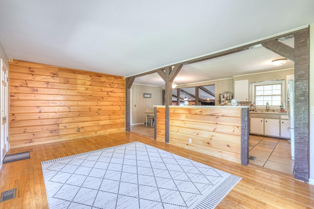 1111 Greenhill St, Murfreesboro, TN 37129 - unfurnished bedroom with hardwood / wood-style flooring, a sink, wood walls, and connected bathroom