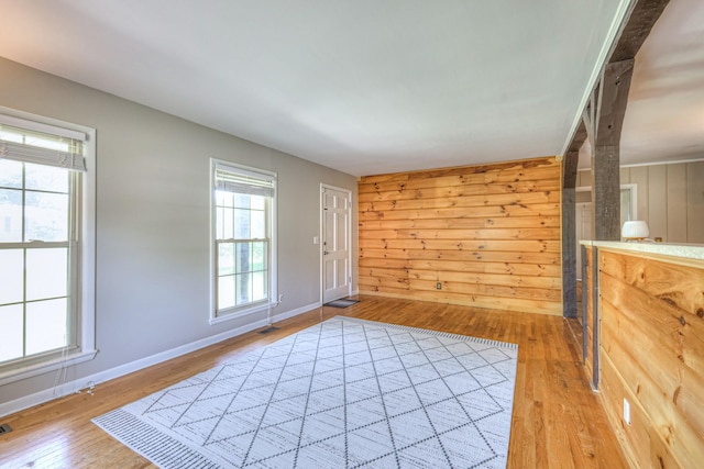 1111 Greenhill St, Murfreesboro, TN 37129 - unfurnished living room featuring light wood-style floors, wooden walls, and baseboards