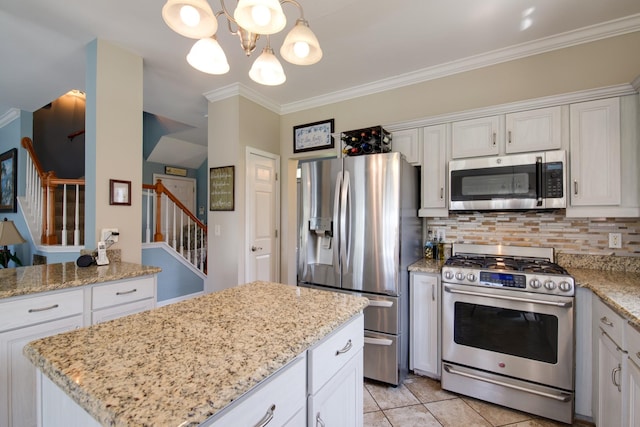 237 Dandridge Dr, Franklin, TN 37067 - kitchen featuring stainless steel appliances, ornamental molding, backsplash, a chandelier, and a kitchen island