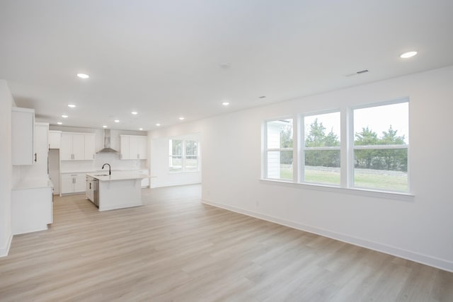133 W Cassa Way, Mount Juliet, TN 37122 - unfurnished living room featuring a sink, recessed lighting, light wood-style floors, and baseboards