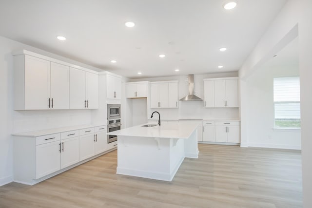 133 W Cassa Way, Mount Juliet, TN 37122 - kitchen featuring a sink, wall chimney exhaust hood, appliances with stainless steel finishes, white cabinetry, and recessed lighting