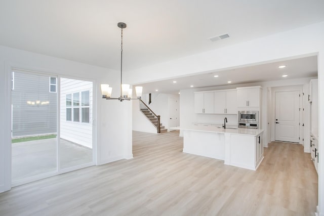 133 W Cassa Way, Mount Juliet, TN 37122 - kitchen featuring stainless steel appliances, a sink, a chandelier, light wood-style flooring, and recessed lighting