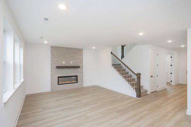 133 W Cassa Way, Mount Juliet, TN 37122 - unfurnished living room featuring light wood-type flooring, stairs, recessed lighting, and baseboards