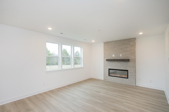 133 W Cassa Way, Mount Juliet, TN 37122 - unfurnished living room featuring a large fireplace, light wood finished floors, recessed lighting, and baseboards