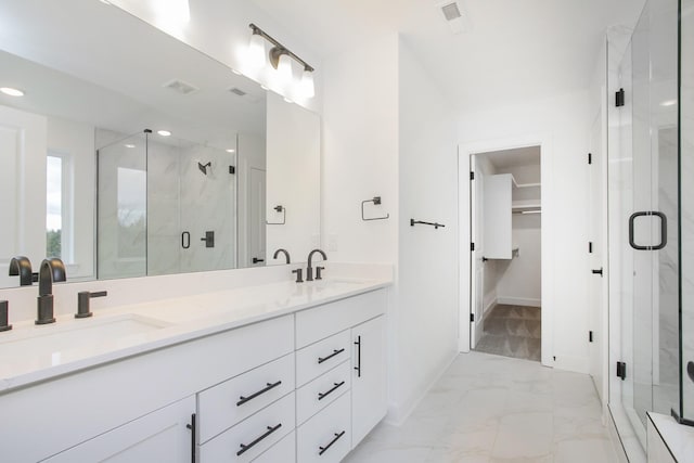 133 W Cassa Way, Mount Juliet, TN 37122 - bathroom with marble look tile flooring, a shower stall, double vanity, a walk in closet, and baseboards