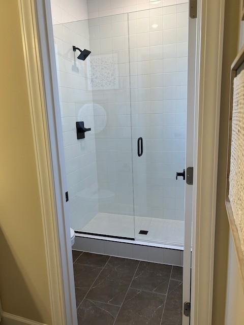 131 W Cassa Way, Mount Juliet, TN 37122 - bathroom with a stall shower, toilet, and marble look tiles