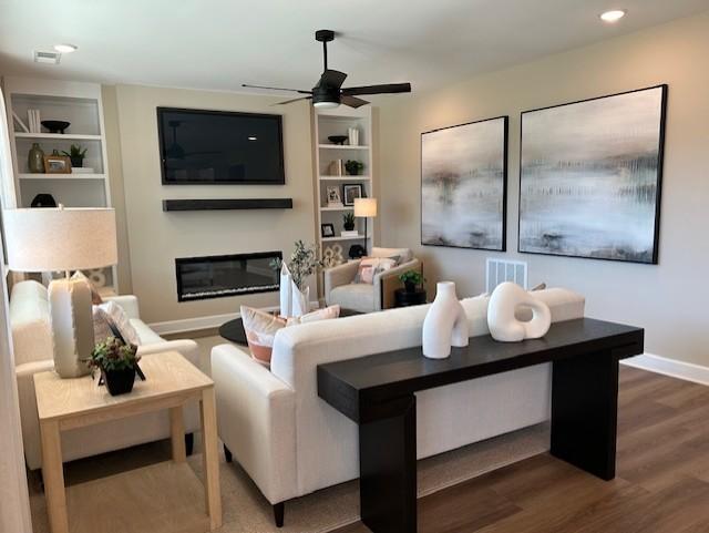 131 W Cassa Way, Mount Juliet, TN 37122 - living room with ceiling fan, wood finished floors, a glass covered fireplace, baseboards, and built in shelves